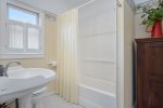 Full bathroom with a shower tub combo just outside the queen bedroom